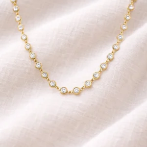 Collier Serenity Melaneen doré oxydes ronds sertis sur tissu